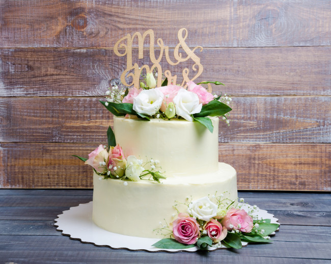two layered wedding cream cheese cake with roses and eustoma